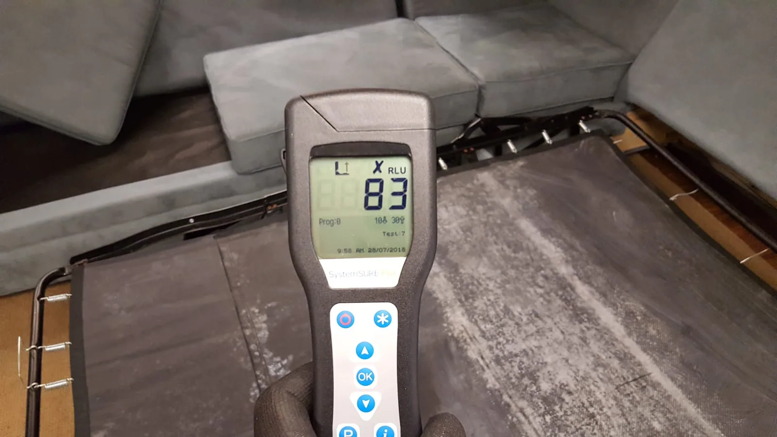 SystemSURE Plus ATP meter verifying surface hygiene on upholstery after cleaning