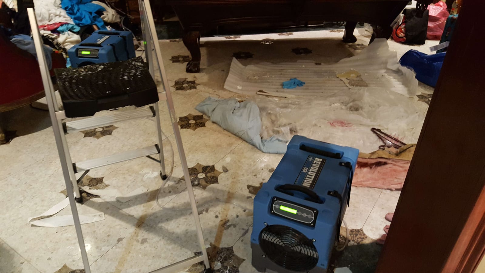 Industrial blue LGR dehumidifiers actively drying a water-damaged interior in Yonkers NY
