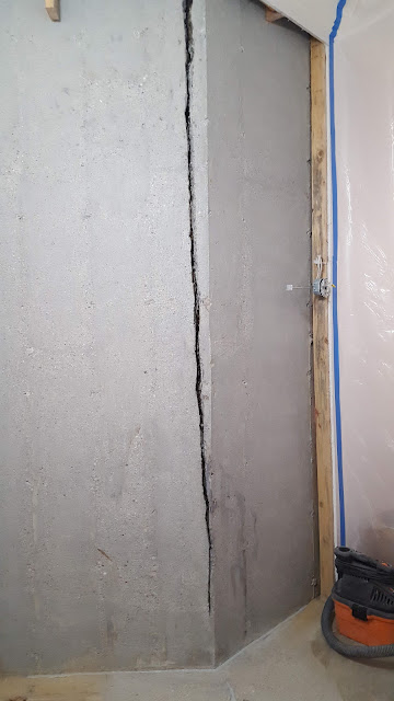 Active water leaking through foundation wall behind paint
